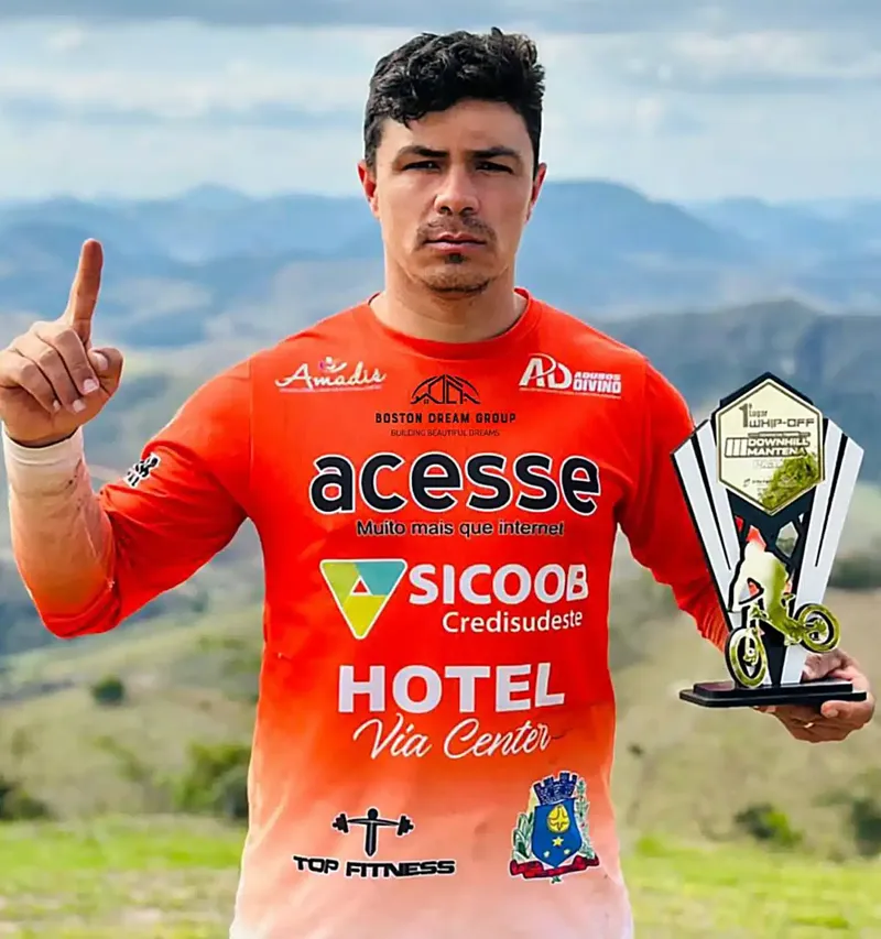 Downhill cyclist Sullivan Piller holding a trophy